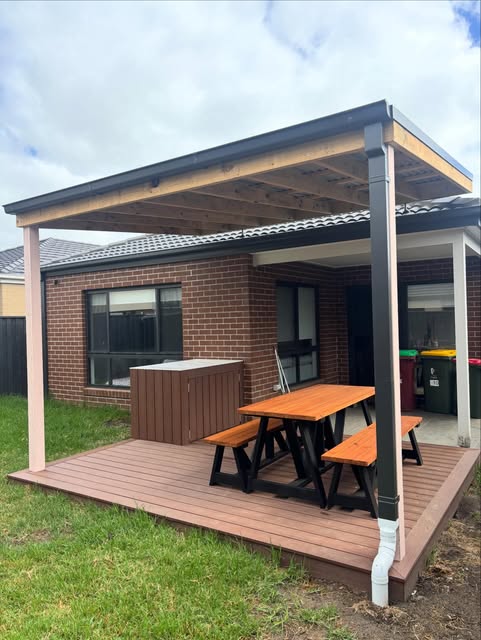 Timber deck under a finished pergola with outdoor furniture